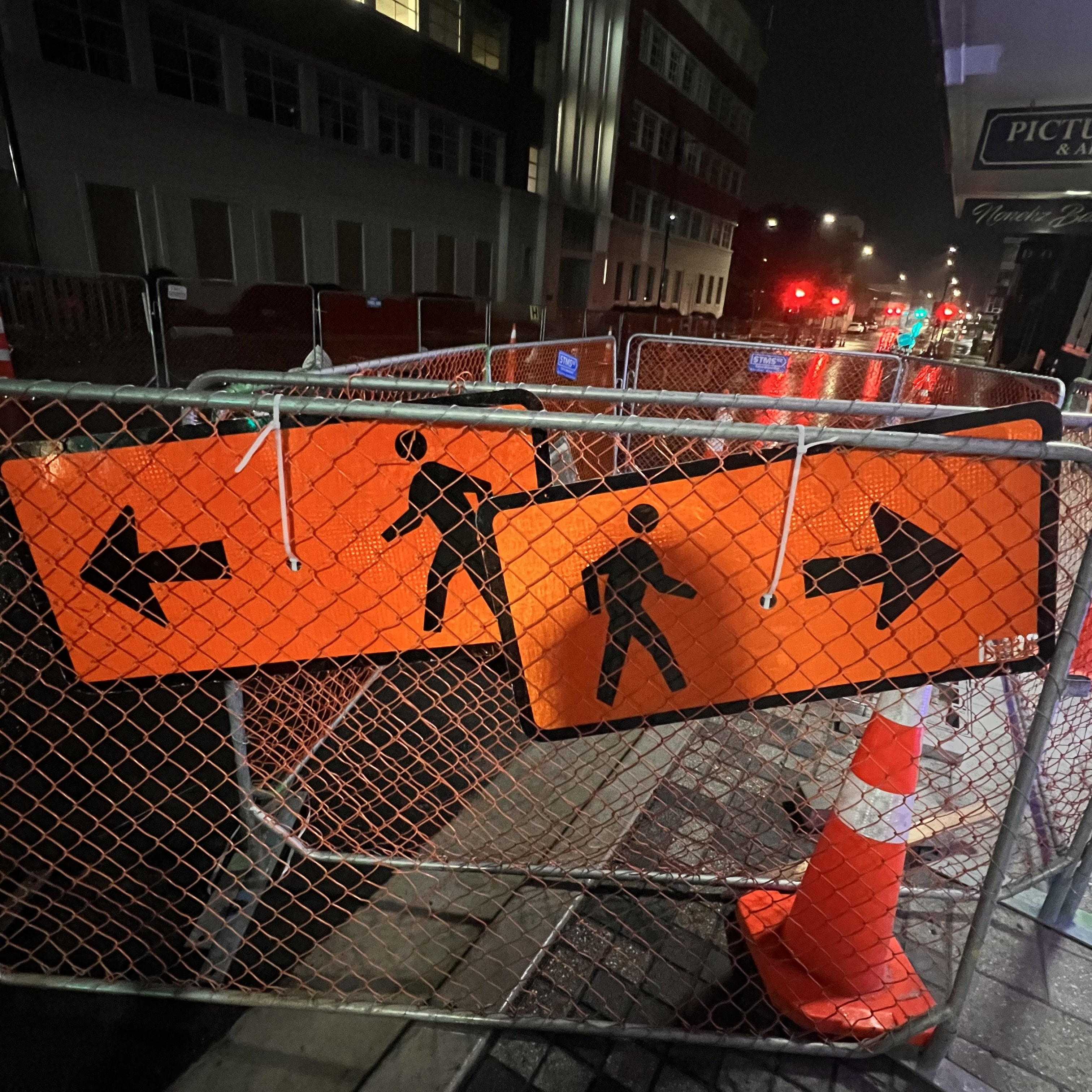 An image of two pedestrian walking signs, pointing in opposite directions.